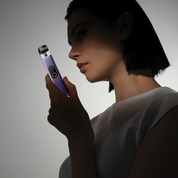 Woman holding VAPORESSO XROS 4 Vape Kit in lilac purple