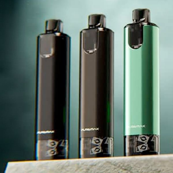 Three SXMini Puremax vapes of different colors in front of glowing green backdrop lined up to express the range of color Three SXMini Puremax vapes of different colors in front of glowing green backdrop lined up to express the range of color