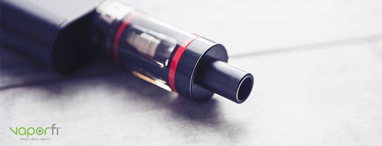 black and red vape tank laying on its side